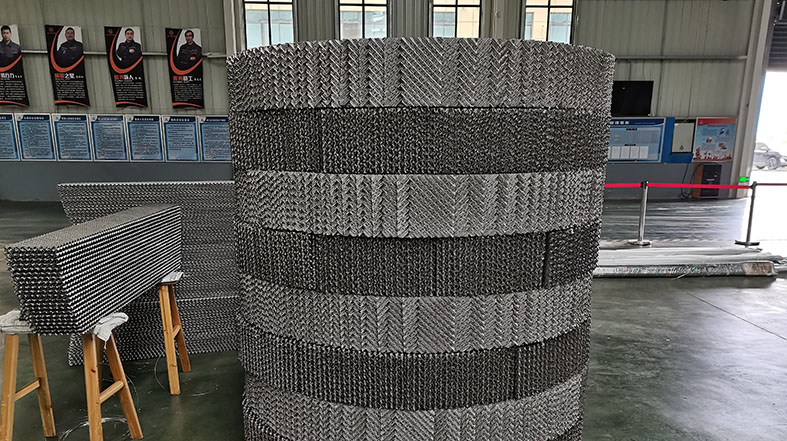 Close-up of 500Y metal structured packing showing 45 degree corrugated sheets with opposite orientations